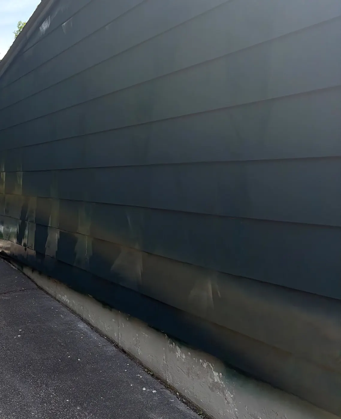 Exterior House Painting in Cumberland, RI — photo 2 — Detail: even coat down to the foundation line