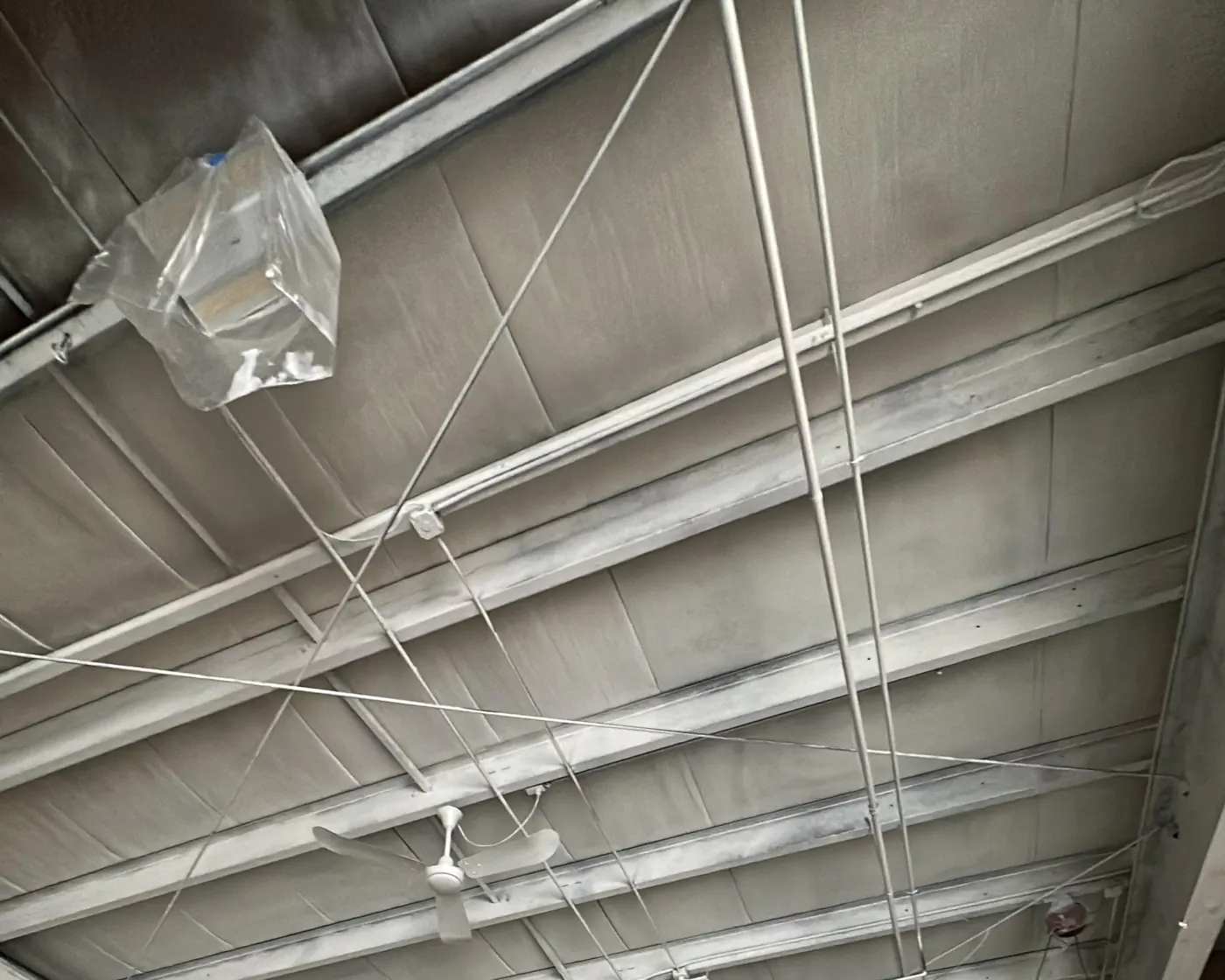 Epoxy Floor Coating in Bellingham, MA — photo 3 — Ceiling and walls masked for spraying