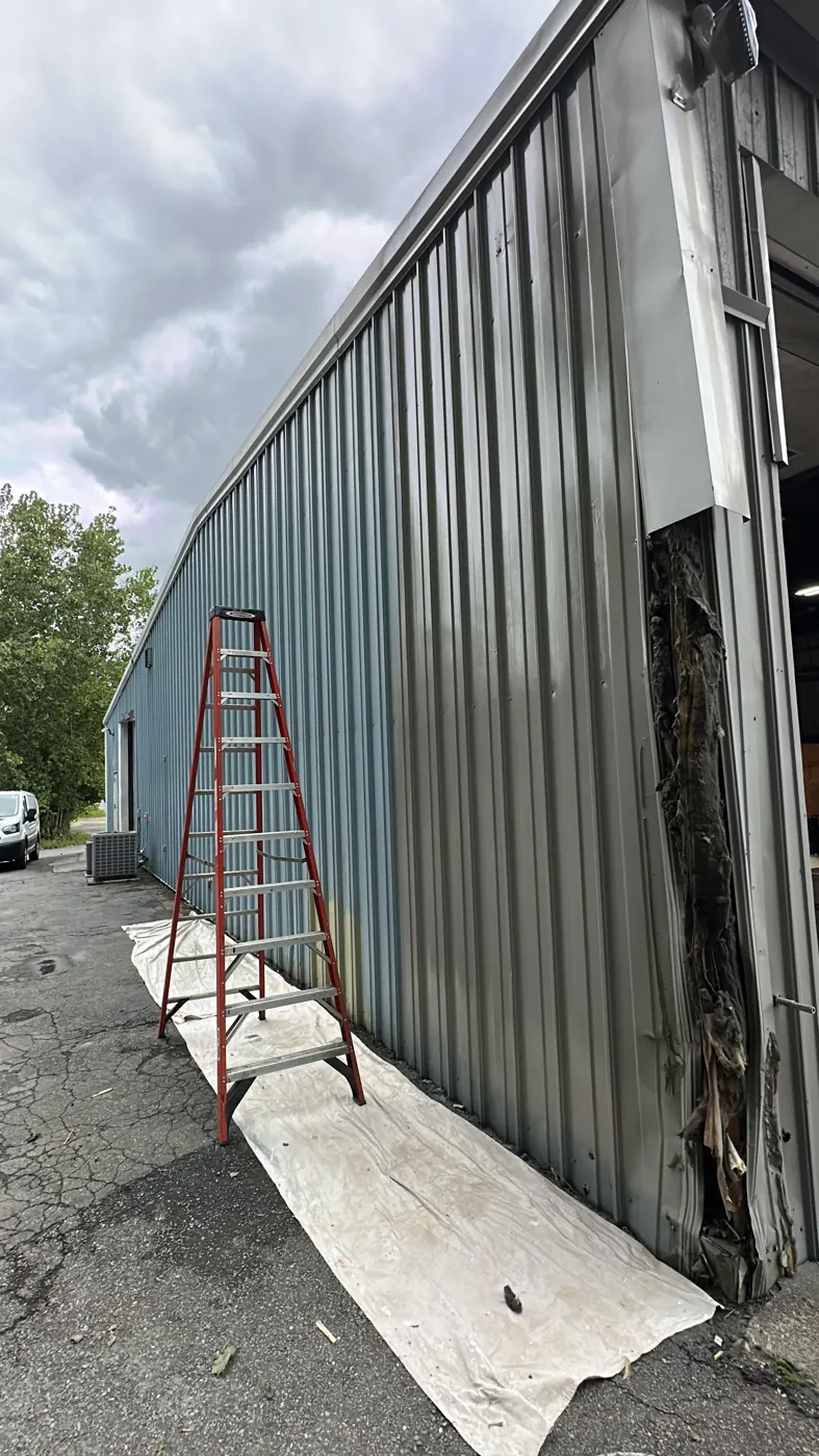 Exterior House Painting in Woonsocket, RI — photo 3 — Spraying the second coat, ground covered