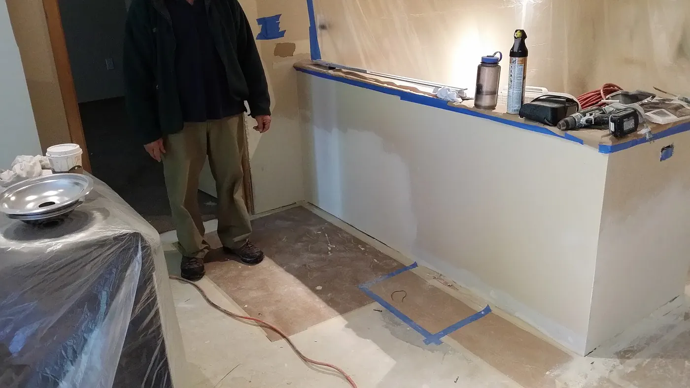 Interior Painting in Bellingham, MA — photo 4 — Counters and floors masked before priming